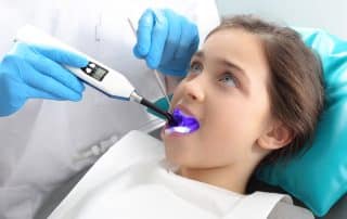 Child in the dental chair dental treatment during surgery.