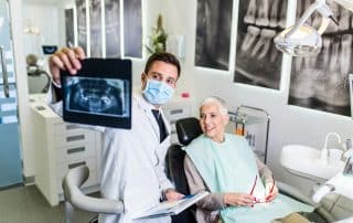 dentist showing woman dental xrays